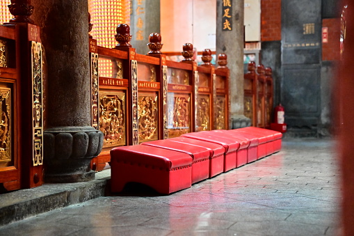 TW-04.05.24: A close-up view of prayer kneeler inside Shilin Cixian Temple (士林慈諴宮), these traditional furnishings serve as sacred seats for devotees to kneel in reverence before the deities.