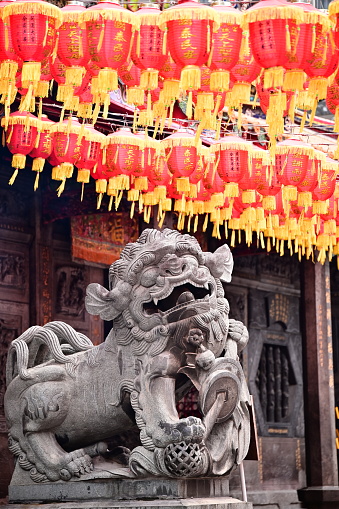 TW-04.05.24: Guardians of Tradition: Close-up of stone lions at the entrance of Shilin Cixian Temple (士林慈諴宮), with traditional Chinese red lanterns in the background.