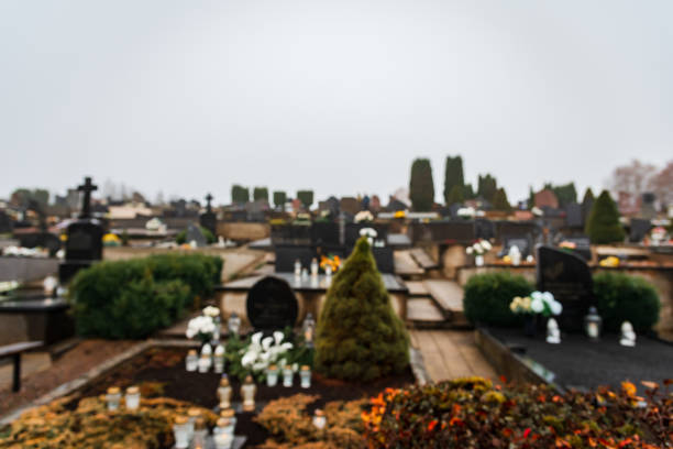 Defocused decorated graves on Cemetery just before All Saints Day.Foggy day.