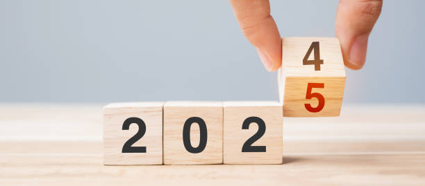 istock hand flip cube block 2024 to 2025 text on table. Resolution, review, strategy, end year, goal, business and New Year holiday concepts 2149791713