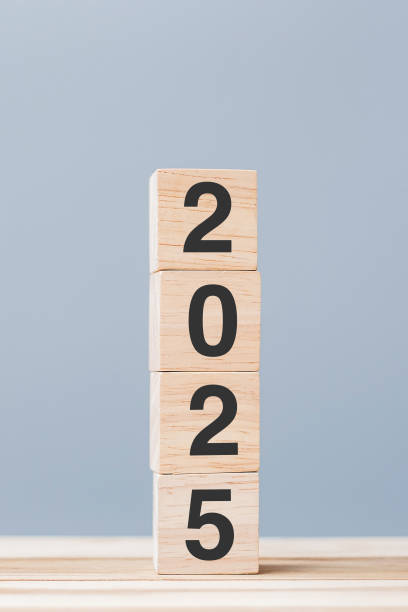 istock wooden cube block with 2025 text on table background. Resolution, plan, review, goal, start and New Year holiday concepts 2149791714