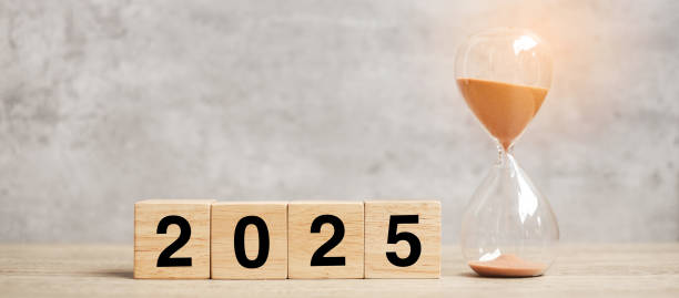 istock 2025  text with hourglass on table. Resolution, time, plan, goal, motivation, reboot, countdown  and New Year holiday concepts 2149791760