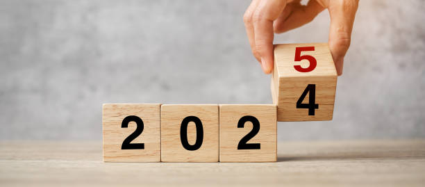 istock hand flipping block 2024 to 2025  text on table. Resolution, strategy, plan, goal, motivation, reboot, business and New Year holiday concepts 2149791786