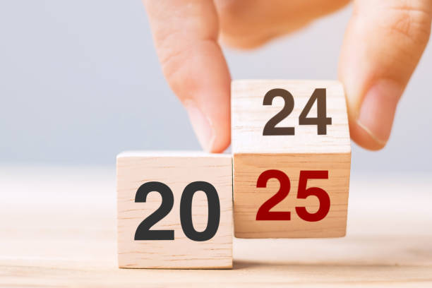 istock hand flip cube block 2024 to 2025 text on table. Resolution, review, strategy, end year, goal, business and New Year holiday concepts 2149791849