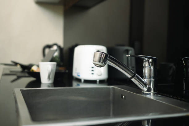 istock Stainless steel kitchen sink and tap water in modern kitchen. 2149792097