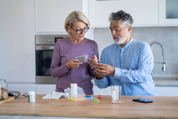 istock Senior couple are organizing their medication into a pill box 2149792147