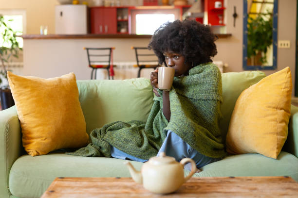 istock Woman with flu sipping hot tea from a mug 2149792186