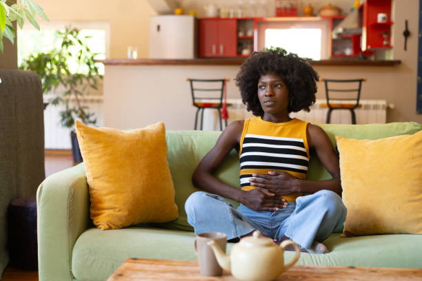 An unhappy woman with stomach pain
