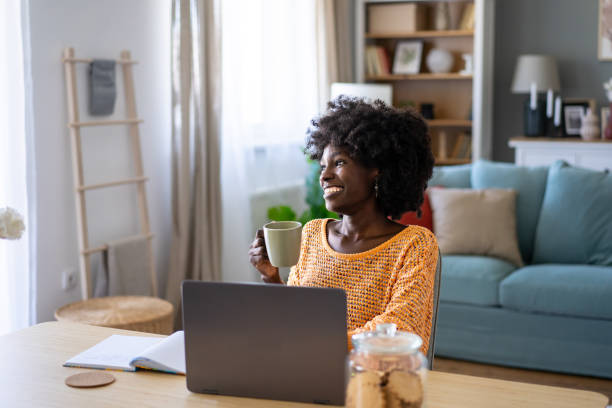 istock Cheerful woman with coffee while working at home 2149792212