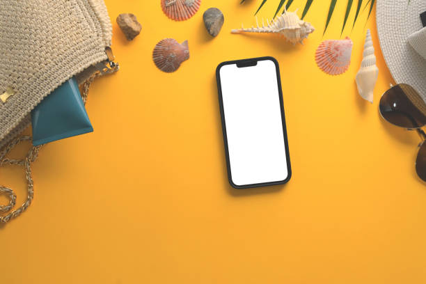 istock Smartphone with blank screen, sunglasses, straw hat and seashells on yellow background 2149792281
