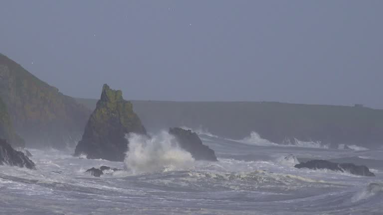 Violent storm massive swell and crashing waves over sea stack at Copper Coast Waterford Ireland