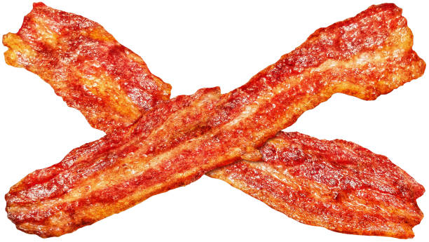 Freshly Fried Pair Of Crunchy Gourmet Criss-Crossed Bacon Rashers Isolated On White Background High Resolution Stock Image Pair of criss-crossed gourmet juicy freshly fried Pork Belly Bacon Rashers, isolated on white background, high resolution stock image. cooked bacon slice stock pictures, royalty-free photos & images