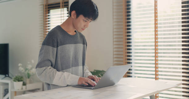 istock Asian Businessman Focused on Laptop Work at Home. 2149793769