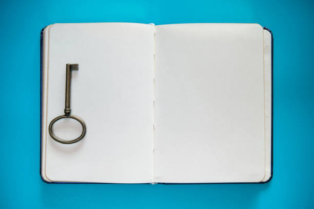 The key lying on old book The key lying on old book on blue background diary lock book cover book stock pictures, royalty-free photos & images