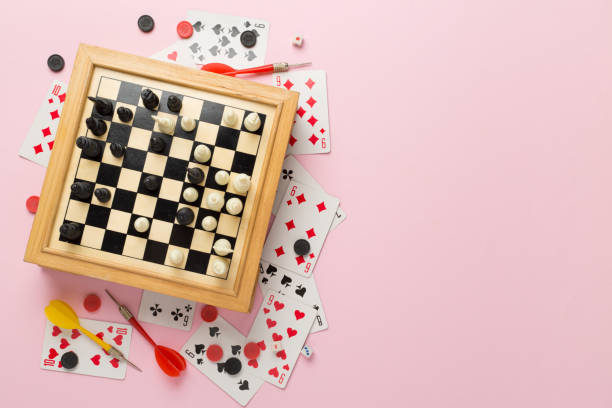 Different board games on color background, top view Different board games on color background, top view board game piece stock pictures, royalty-free photos & images