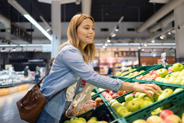 istock Woman picking vegetables at grocery store 2149795295
