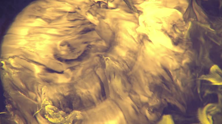 A mesmerizing golden river of bright swirls of yellow-orange flames. 3d rendering digital animation 4K