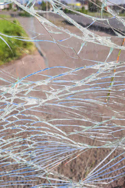 istock Vandalised Broken bus stop in the city. Dangerous, crashed tempered glass pieces on ground 2149798711