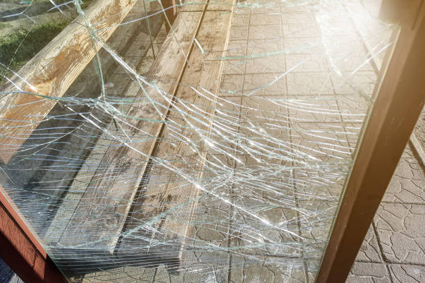 istock Vandalised Broken bus stop in the city. Dangerous, crashed tempered glass pieces on ground 2149798724