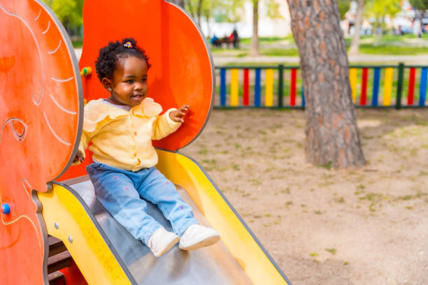 istock An african girl playing on a slide 2149799755