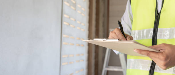 istock inspector or engineer is inspecting construction and quality assurance new house using a checklist. Engineers or architects or contactor work to build the house before handing it over to the homeowner 2149799851
