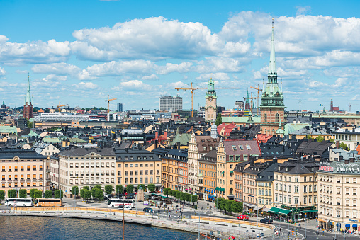 Blue summer skies above the landmarks of Stockholm, Sweden's vibrant capital city, and the historic townhouses, restaurants and bars of Gamla Stan.