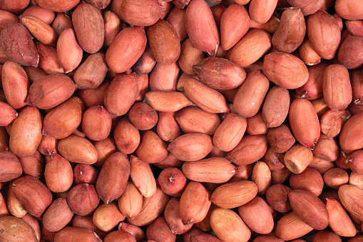 Background of shelled peanuts, top view. Nuts food background.