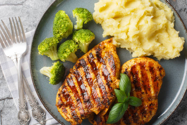 istock Grilled chicken with broccoli and mashed potatoes closeup on the plate. Horizontal top view 2149800002