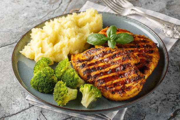 istock Roast breast grilled chicken with broccoli and mashed potatoes closeup on the plate. Horizontal 2149800017