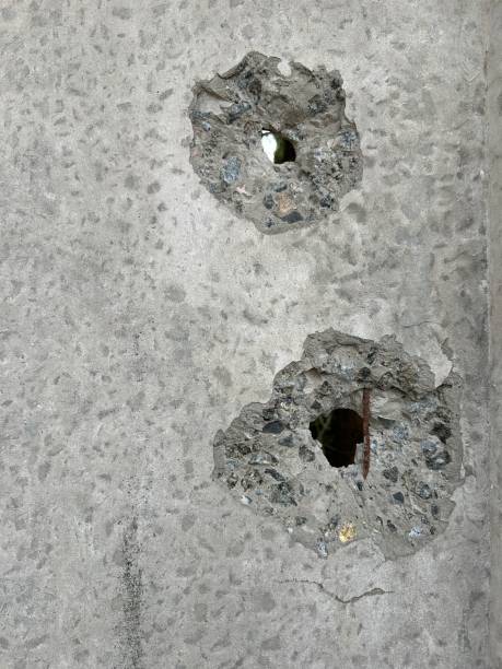 bullet hole in weathered metal surface
