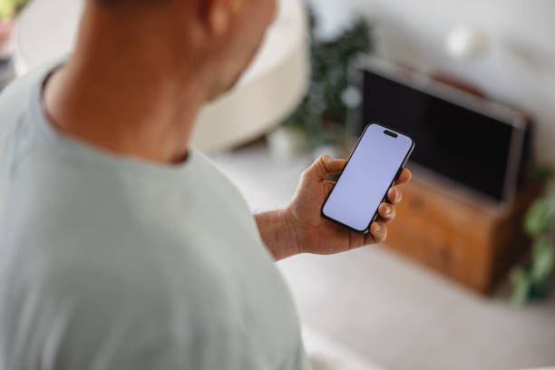 istock Adult Man Holding Smartphone with Blank Screen 2149802245