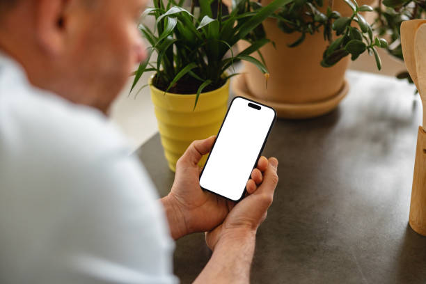 istock Adult Man Using Smartphone with Blank Screen at Home 2149802250