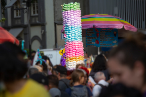 Multi coloured candy floss for sale at the huge annual parade that takes place in Mexico City as part of the Day of the Dead celebration that takes place at the end of October. Huge crowds line the street to see dancers and floats make their way through the city