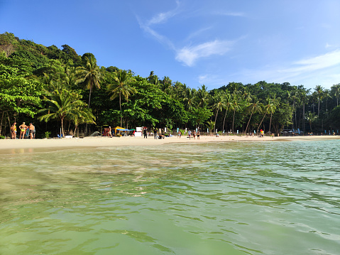 Tourists sunbathing at the Idyllic Freedom Beach in Phuket, a hidden strip of white sand near Patong, Thailand