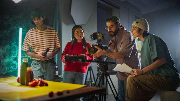 istock Diverse Young Film Crew Engaged In A Creative Video Production Session On A Vibrant Set, Surrounded By Modern Equipment And Colorful Props, Focusing On Capturing Engaging Content For A Dynamic Project 2149805492