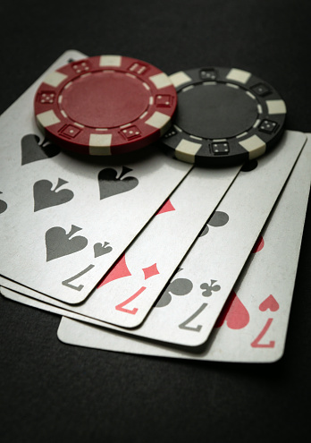 Successful win with four playing cards. Poker game with four of a kind or quads combination.