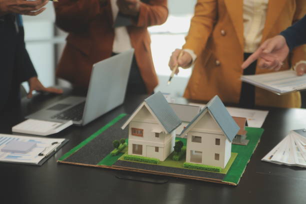 istock Team of architectures and businessmen discussing and brainstorming on floor plan modification for real estate investment and housing development project 2149807575