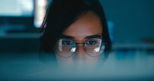 Closeup of Female computer programmer works on complex software development tasks at her home office late into the night. Software developer, artificial intelligence and programming. Closeup of Female computer programmer works on complex software development tasks at her home office late into the night. Software developer, artificial intelligence and programming concept. asian female engineer stock pictures, royalty-free photos & images