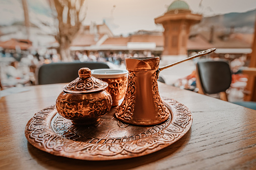 In Sarajevo's historic cafes, vintage copper coffee pots evoke the aroma of tradition and the warmth of East.