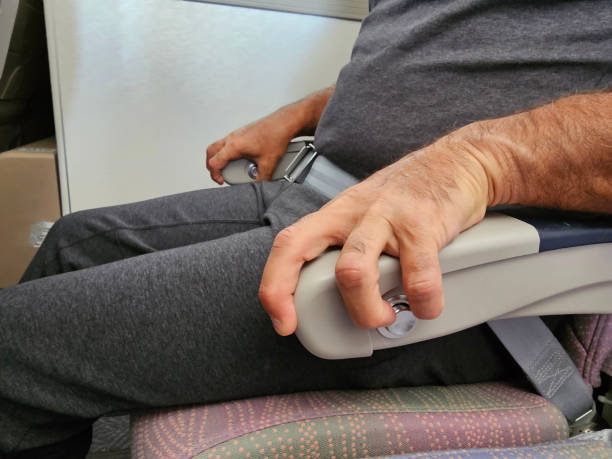 Man Sitting in Chair Holding Cell Phone