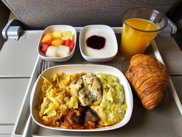 A tray displaying a croissant, multiple croissants, and an assortment of fruit