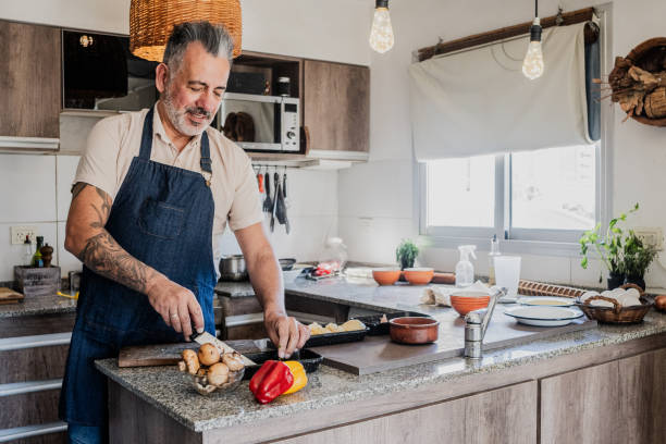 istock Mature man cooking in the kitchen at home 2149809992