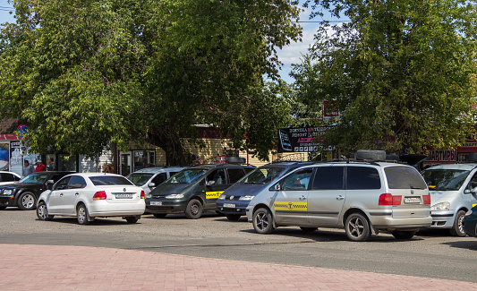 Uralsk, Oral, Kazakhstan (Qazaqstan), 06.08.2019 - Cars of Atyrau taxi drivers in the area of the railway station in Uralsk.