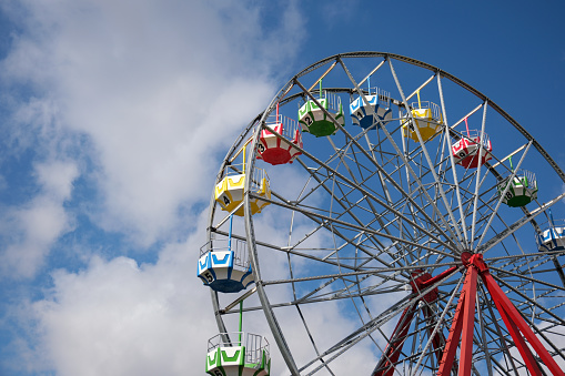 Low angle view of large Ferris Wheel against clear sky with copy space.