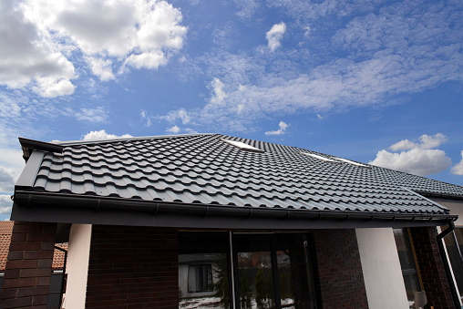 Corrugated metal roof tile on house sky bacground