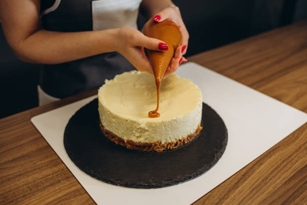 istock Close up woman is decorating the cake 2149810455