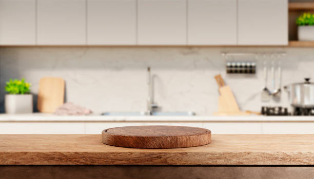 istock Kitchen counter with empty wooden board and blur modern kitchen interior background. Food and drink product podium stand tabletop. 2149811460