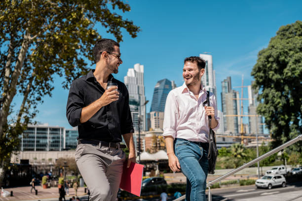 istock Businessmen talking and walking through the city 2149812388