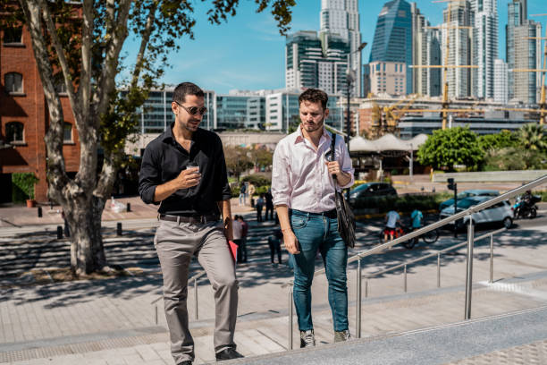 istock Businessmen talking and walking through the city 2149812389
