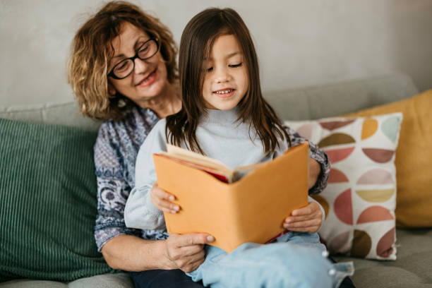 istock Grandma is reading a book to her grandson 2149812920